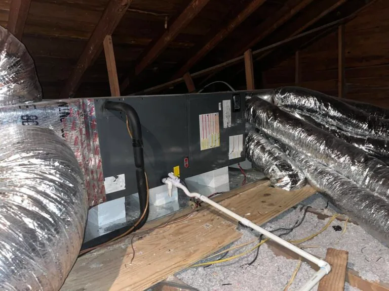 Attic air handler unit with foil-insulated flex ducts and PVC condensate line in West Monroe home