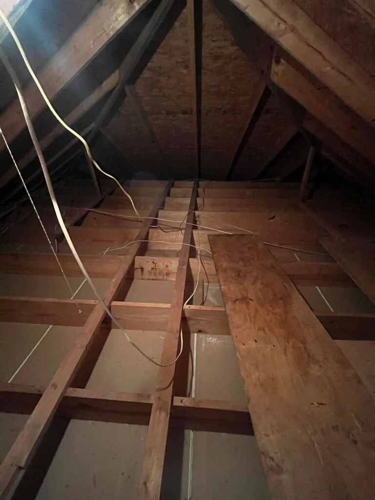 Unfinished attic space with exposed joists and rafters before HVAC installation in West Monroe home