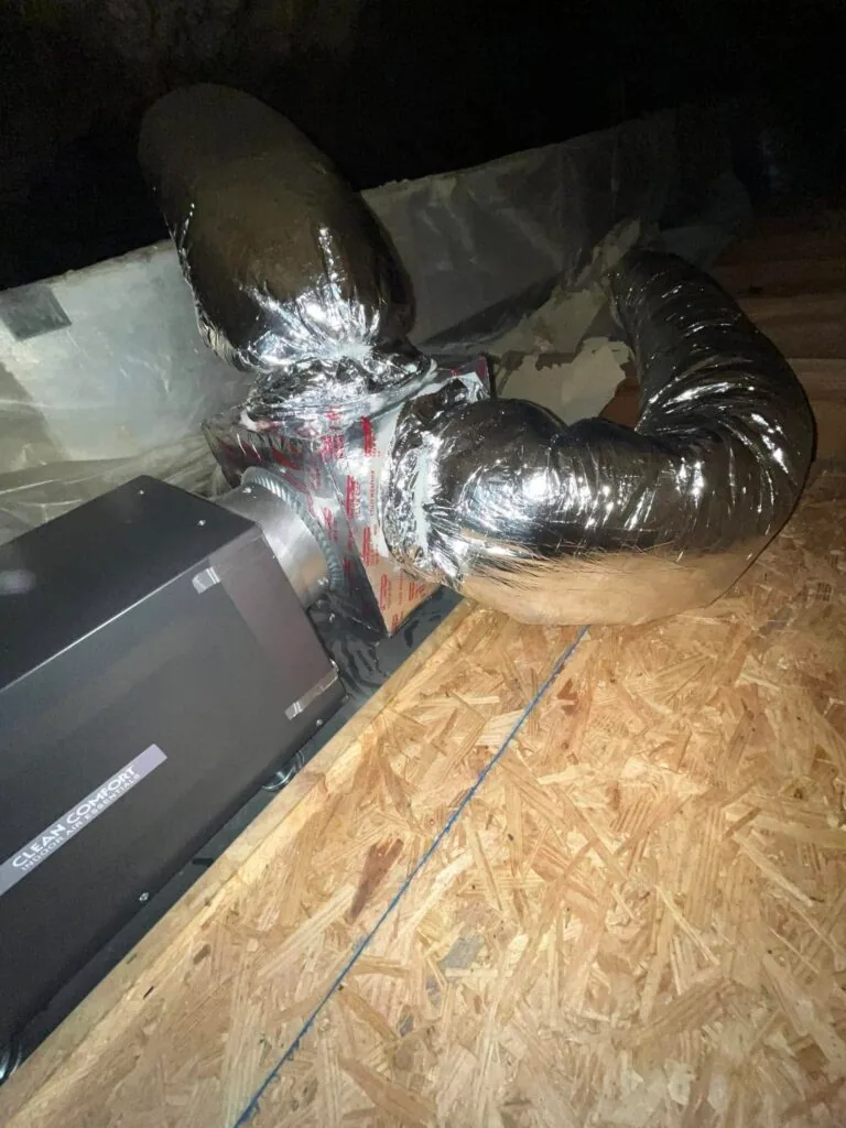 Clean Comfort dehumidifier with insulated ductwork installed on attic decking in West Monroe home