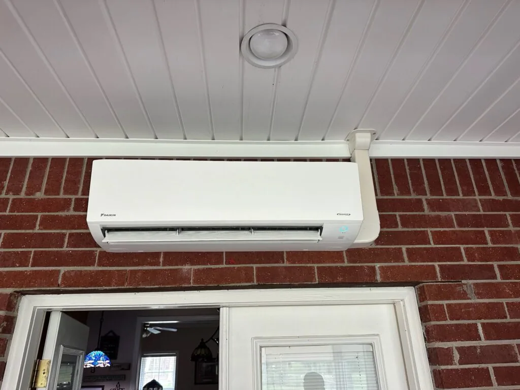 Daikin ductless mini split indoor unit mounted on brick wall above a porch doorway in West Monroe, LA