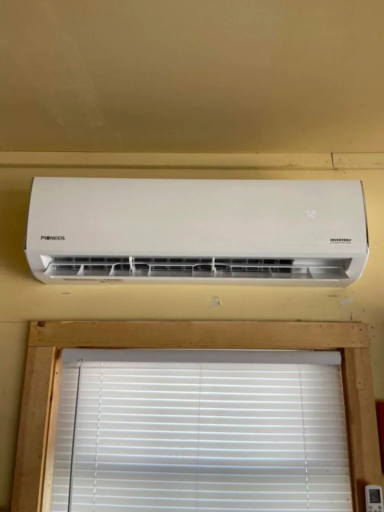 Pioneer ductless mini split indoor unit mounted on wall above a window with blinds, set to 72 degrees